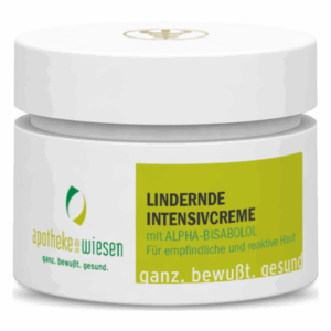 Weißes Cremetiegel mit grünem Etikett, Beschriftung 'Lindernde Intensivcreme mit Alpha-Bisabolol', für empfindliche Haut.