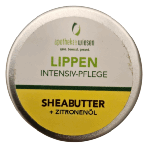 Dosenverpackung mit Lippenpflege, enthält Sheabutter und Zitronenöl, mit grünem und gelbem Etikett.
